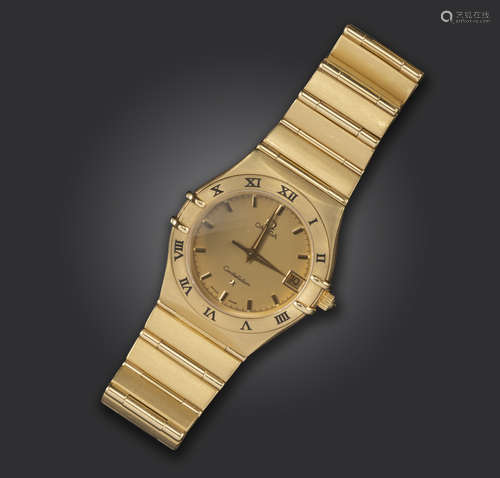 A gold Constellation wristwatch by Omega, the signed textured champagne dial with gilt baton