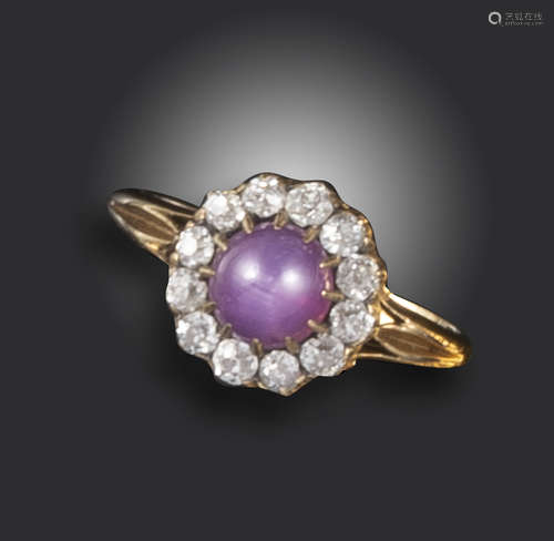 A Victorian star sapphire and diamond cluster ring, the star sapphire cabochon set within a surround