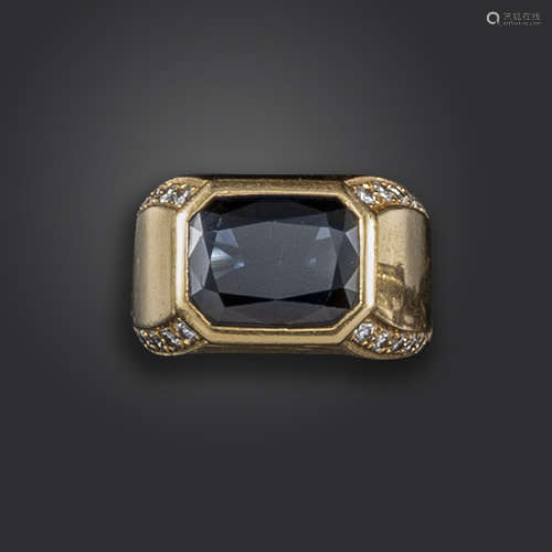 A sapphire and diamond-set gold ring, centred with a rectangular-shaped sapphire, with circular-