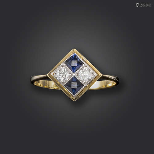 A sapphire and diamond cluster ring, lozenge-shaped and set with round brilliant-cut diamonds and