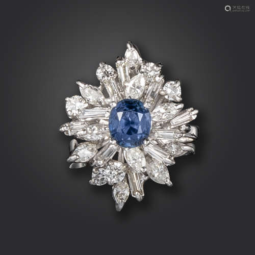 A sapphire and diamond dress ring, the oval-shaped sapphire set within a surround of marquise,