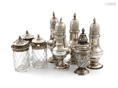 A mixed lot of silver condiments, comprising: four George III pepper pots, baluster form, flame,