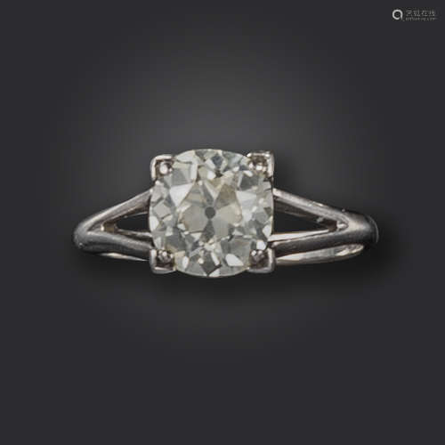 A diamond solitaire ring, set with an old circular-cut diamond in a square-shaped claw mount, with