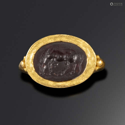 A Roman garnet intaglio depicting a horse, c1st century BC - 1st century AD, the horse grazing and