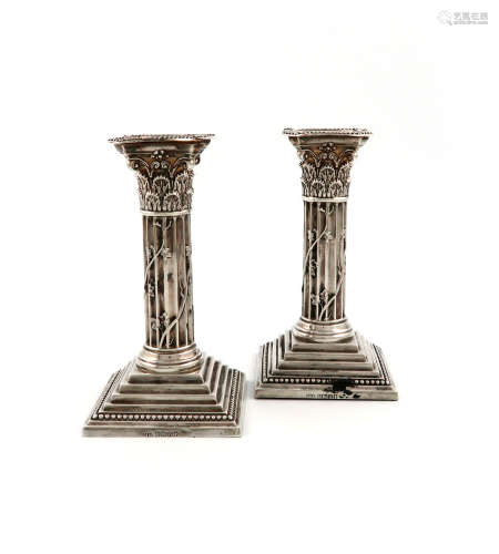 A pair of Victorian silver candlesticks, by The Harrison Brothers, Sheffield 1889, Corinthian column