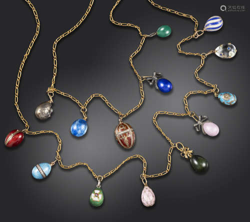 An early 20th century gold necklace suspending fourteen miniature egg pendants, including a chick