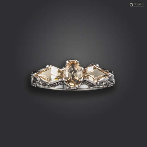 A topaz and diamond three-stone ring, set with a duchess-cut and two kite-shaped topaz, with