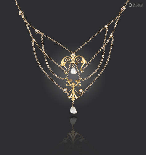 An Art Nouveau gold necklace, of scrolling gold form suspended from fine-link gold chains with