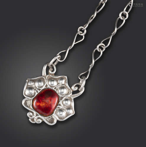 An Arts & Crafts silver and red enamel pendant by Ramsden & Carr, the silver trefoil decorated