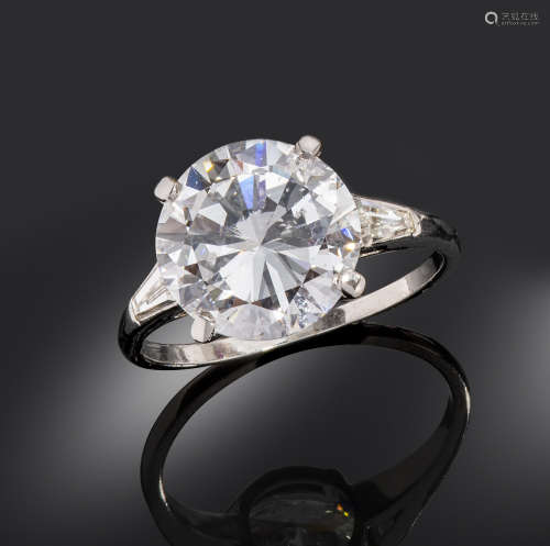 A diamond solitaire ring, the round brilliant-cut diamond weighs 5.23cts, set with two tapered