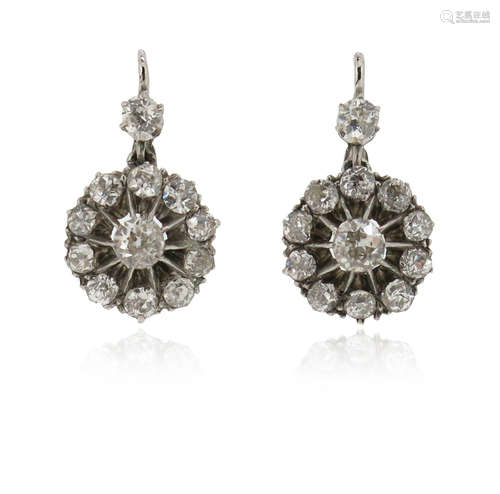 A pair of diamond drop earrings, the old circular-cut diamonds each suspend a diamond cluster,