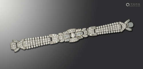 A diamond bracelet, of geometric design, set overall with graduated circular-cut and baguette-shaped