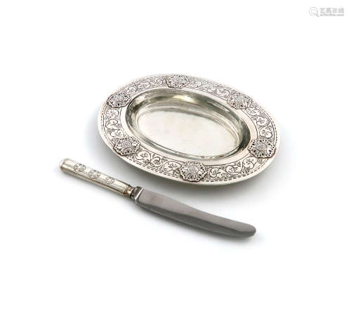 By Liberty and Co., an Arts and Crafts silver butter dish and butter knife, Birmingham 1935, the