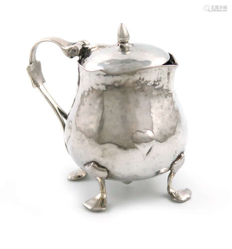 By Liberty and Co, a late-Victorian silver mustard pot, Birmingham 1900, baluster form, embossed