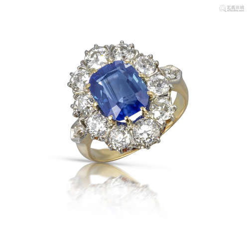 An early 20th century sapphire and diamond cluster ring, the cushion-shaped sapphire weighs 4.