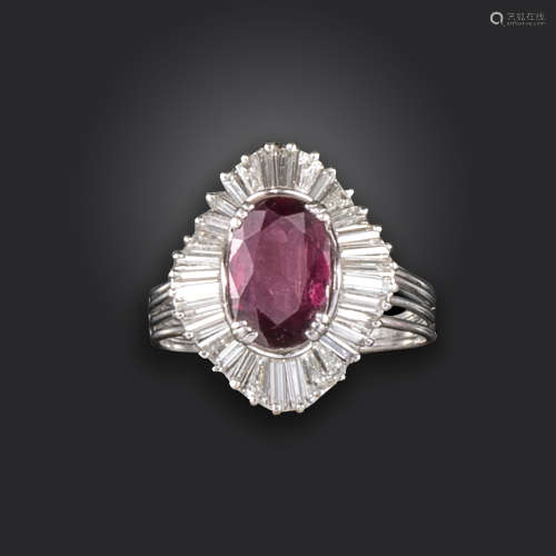 A ruby and diamond cluster ring, centred with an oval-shaped ruby weighing approximately 1.90cts,