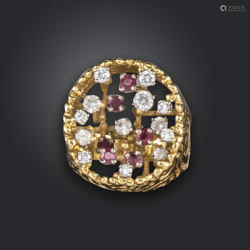 A ruby and diamond dress ring, the pierced cylindrical yellow gold mount set with varying raised