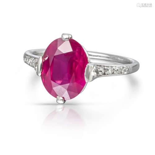 A ruby and diamond ring by Cartier, the oval-shaped ruby weighs 3.30cts, set with five circular-