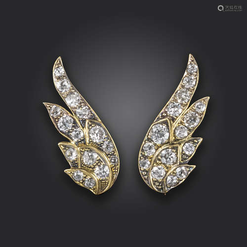 A pair of diamond-set earrings, in the form of stylised wings, set with graduated circular-cut