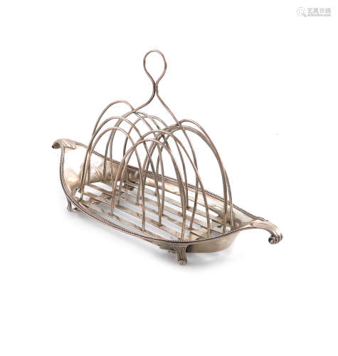 A George III silver toast rack, by Robert Hennell, London 1785, oval navette form, fluted ends, with