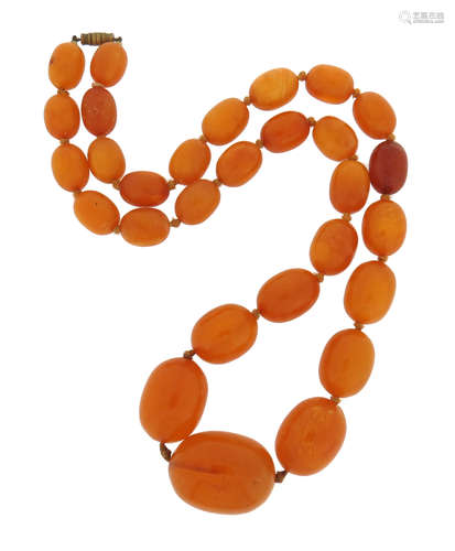 A single-row amber bead necklace, the beads graduate from 12 - 28mm, 62cm long, 90g total