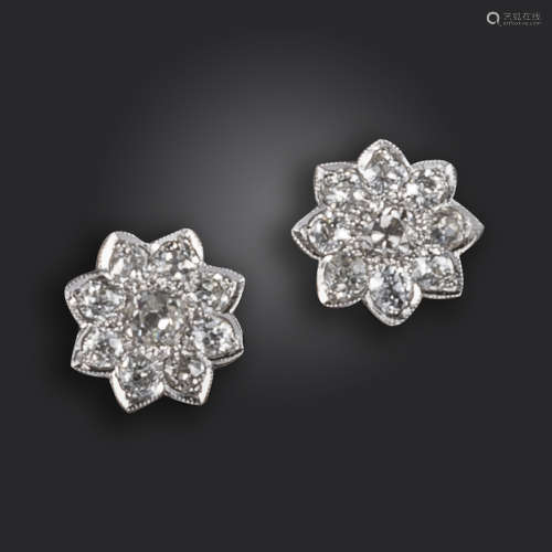 A pair of diamond flowerhead cluster earrings, set with old circular-cut diamonds in white gold,