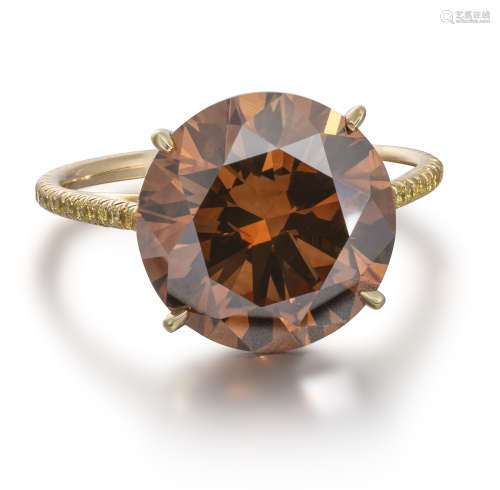 A fancy-coloured diamond ring, the round brilliant-cut diamond weighs 5.59cts, the shank set with