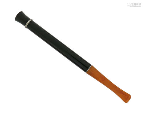 A simulated amber and black onyx cigarette holder, with platinum circle of small circular-cut