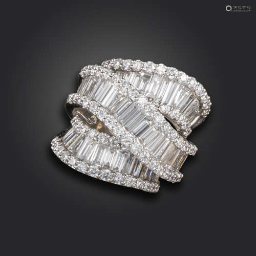 A diamond dress ring, the three undulating scrolls set with graduated baguette-shaped diamonds