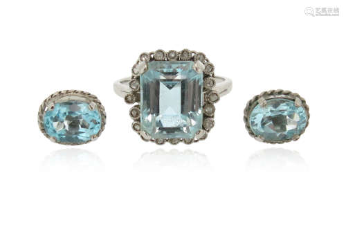 An aquamarine and diamond cluster ring, set with an emerald-cut aquamarine within a surround of