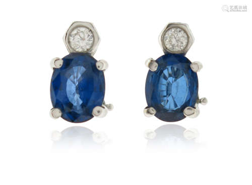 A pair of sapphire and diamond earrings, the round brilliant-cut diamonds suspend oval-shaped