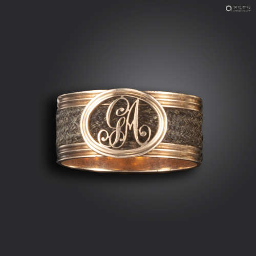 A George III gold mourning ring, the fluted gold shank set with plaited hair and the initials GA,