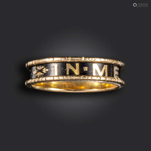 A Victorian black enamel and gold mourning ring, decorated with gold lettering for 'IN MEMORY OF' on