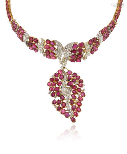 A ruby and diamond-set gold necklace, alternately-set with rubies and diamonds, suspending a leaf-