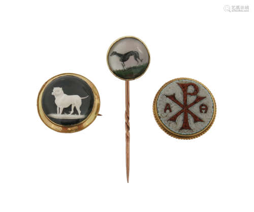 A reverse-carved crystal stick pin, c1900, depicting a greyhound, of circular form and mounted in