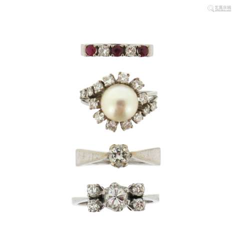 Four gem-set white gold rings, including a diamond solitaire, a diamond five stone ring, a ruby