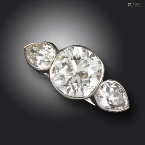 A diamond three-stone ring, the central old cushion-shaped diamond weighs approximately 3.95cts,