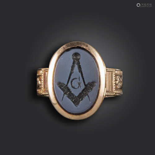 A Masonic gold locket ring, set with a hardstone intaglio with Masonic engraving, on foliate
