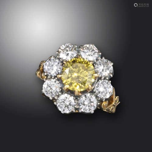 A fancy-coloured diamond cluster ring, the circular-cut fancy-coloured diamond weighs 1.61cts and is
