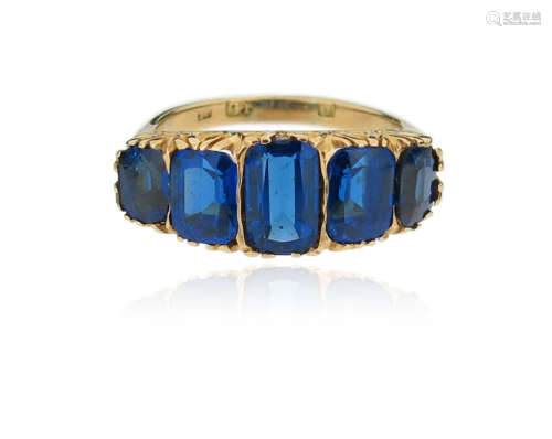 A synthetic sapphire half-hoop ring, set with graduated rectangular-cut synthetic sapphires in