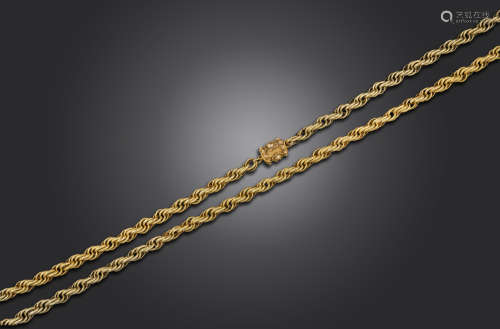 A Regency long guard chain, the twisted circular links with granular decoration in yellow gold,