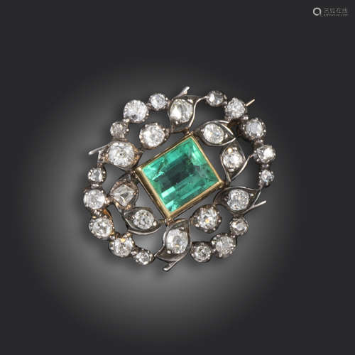 A Victorian emerald and diamond brooch, the rectangular-shaped emerald set within a surround of