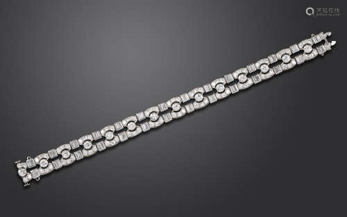 An Art Deco diamond bracelet, mounted with graduated circular-cut and baguette-shaped diamonds