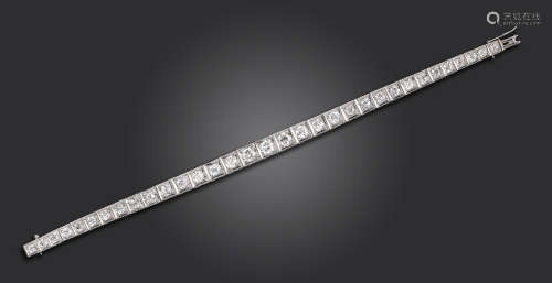 A diamond line bracelet, set with graduated old circular-cut diamonds in square platinum settings,