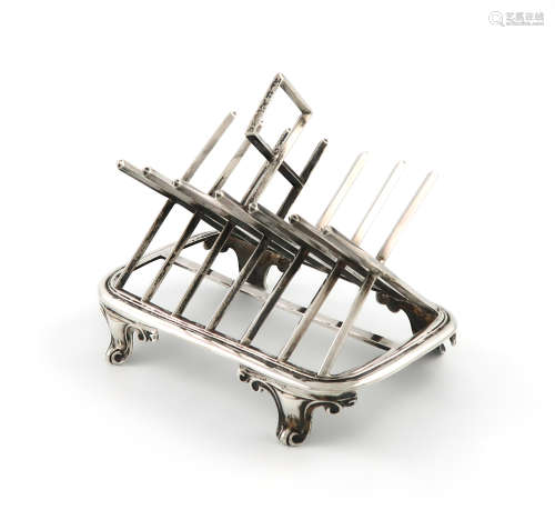 A Victorian silver seven-bar toast rack, by George Fox, London 1865, modelled as saltire bars,