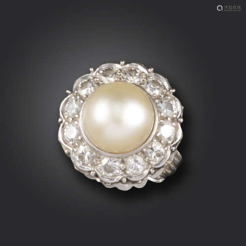 A natural pearl and diamond cluster ring, the natural pearl measures 9.7 - 9.8mm approximately,