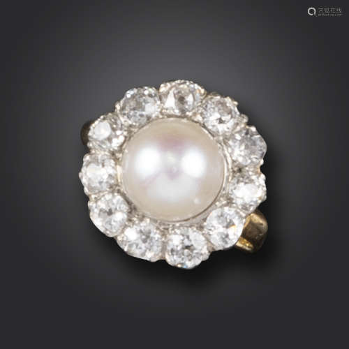 An early 20th century natural pearl and diamond cluster ring, the natural half pearl set within a