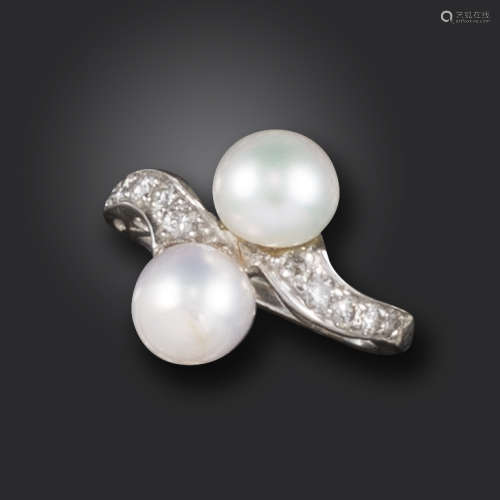 A pearl and diamond crossover ring, set with two pearls with round brilliant-cut diamonds to the