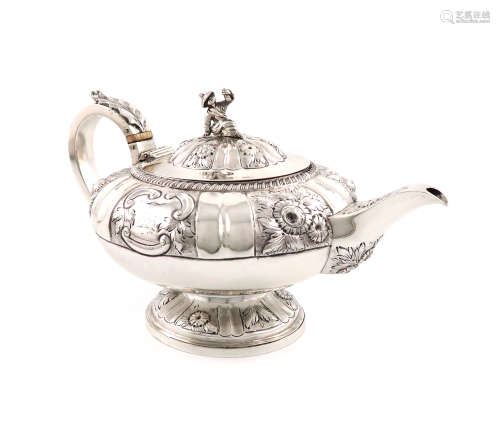 λA George IV silver teapot, by William Traies, London 1824, circular bellied form, embossed