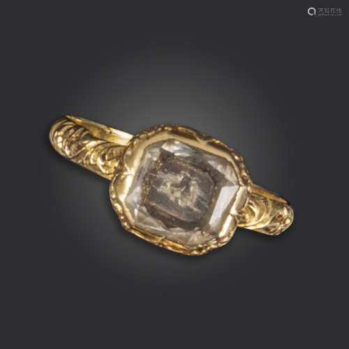 A 17th century Stuart crystal and gold ring, the faceted crystal covers two doves on finely
